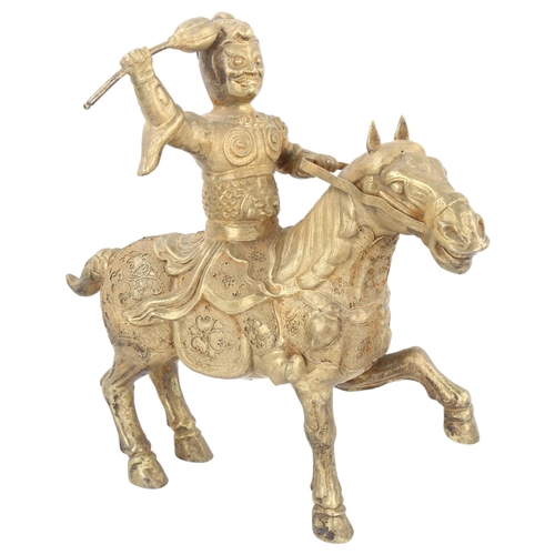 175 - A Chinese unmarked white metal horse and rider, with detailed applied filigree decoration, height 29... 