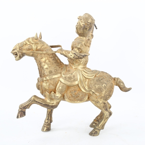 175 - A Chinese unmarked white metal horse and rider, with detailed applied filigree decoration, height 29... 