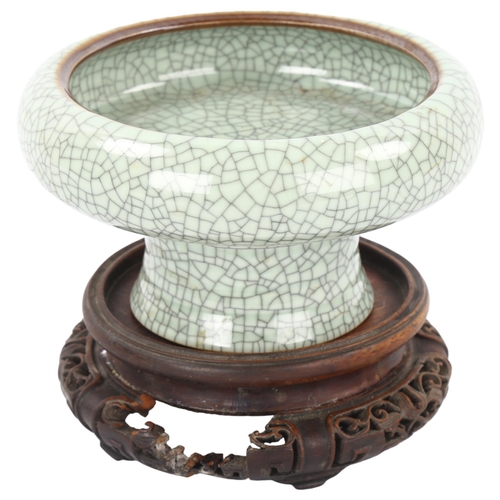 179 - A Chinese celadon crackle glaze Ge-type stemmed bowl, diameter 16cm, on carved wood stand, overall h... 