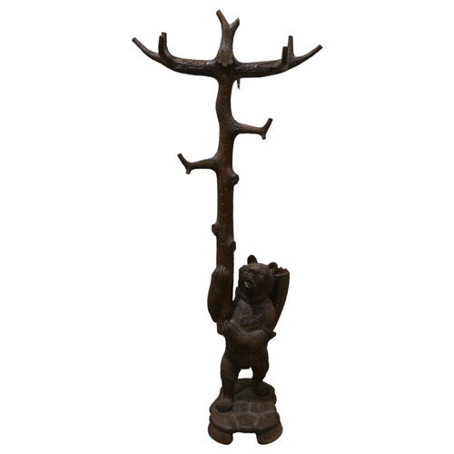 183 - A Black Forest carved wood hall stand, supported by a bear with basket on his back, height 180cm