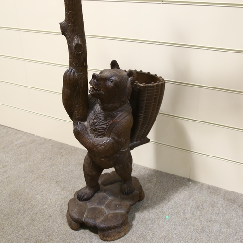 183 - A Black Forest carved wood hall stand, supported by a bear with basket on his back, height 180cm