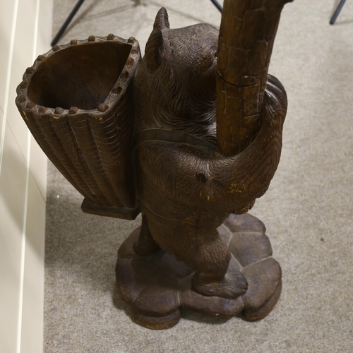 183 - A Black Forest carved wood hall stand, supported by a bear with basket on his back, height 180cm