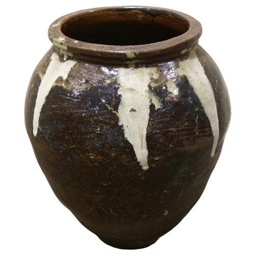 19 - A large Burmese treacle glaze pottery jar, with white glaze streak shoulders, height 60cm