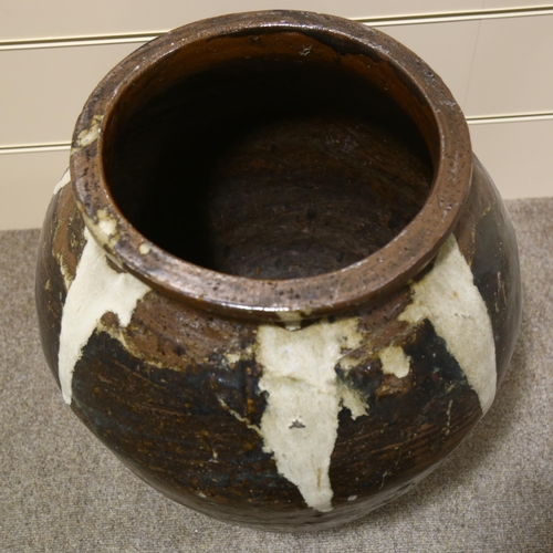 19 - A large Burmese treacle glaze pottery jar, with white glaze streak shoulders, height 60cm