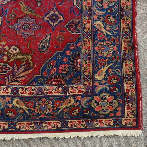 199 - An Antique Persian rug with bird borders, and bird and lion detail to central panel, 185cm x 142cm