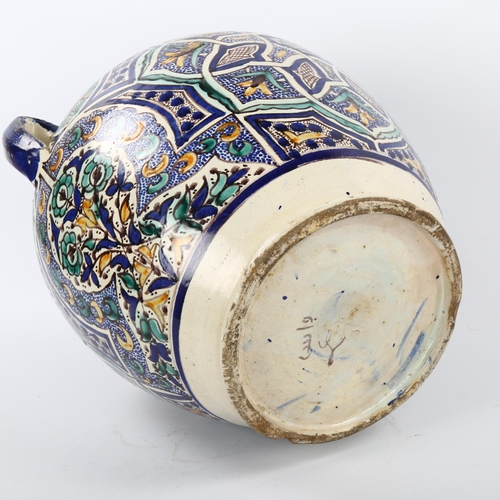 23 - A large Moroccan Islamic pottery 2-handled jar, with hand painted geometric designs, height 36cm