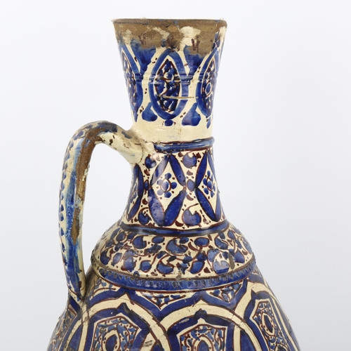 33 - A large Moroccan Islamic pottery wine ewer, height 50cm