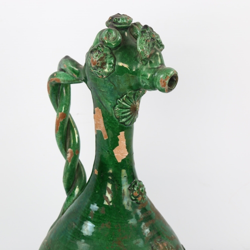 34 - A Turkish Islamic Ottoman green glaze earthenware Canakkale ewer, height 36cm