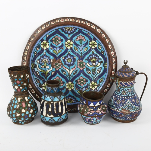 35 - A group of Islamic metalware with enamel decoration, including a charger, diameter 38cm, a wine ewer... 