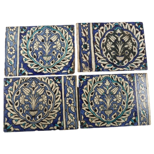 39 - A set of 4 Islamic pottery tiles, with hand painted decoration, 20cm x 27cm (4)