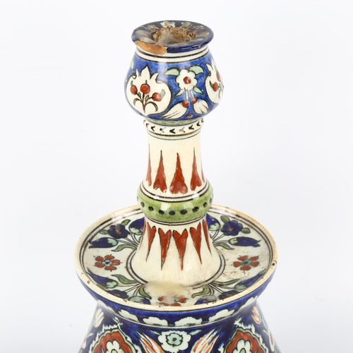 40 - A Portuguese pottery candlestick with painted decoration, height 28cm