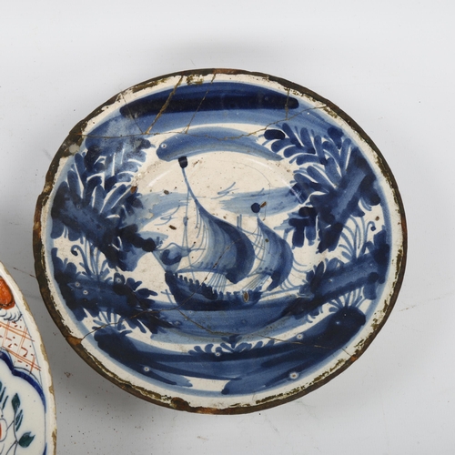 47 - A tin-glazed pottery charger with painted decoration, diameter 24cm, and an early tin-glazed blue an... 