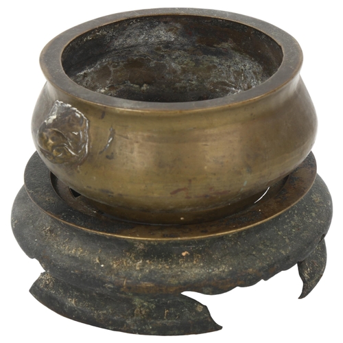 49 - A Chinese patinated bronze incense burner, dog of fo handles, on separate bronze stand, rim diameter... 