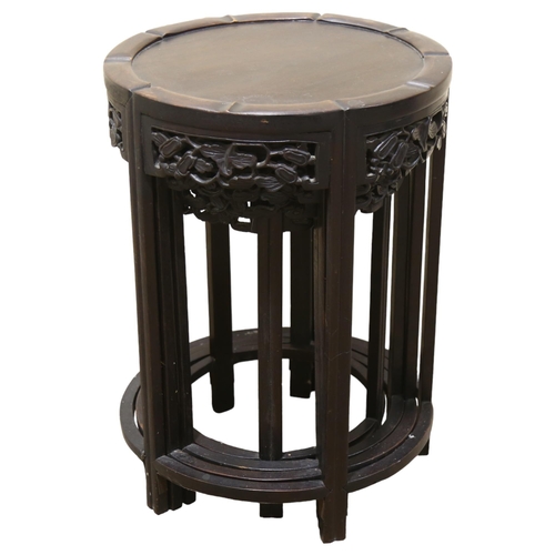 68 - A nest of 4 Chinese circular hardwood occasional tables, with carved friezes, largest table diameter... 