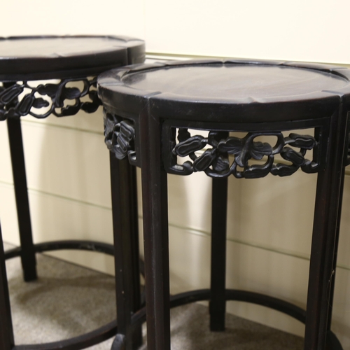 68 - A nest of 4 Chinese circular hardwood occasional tables, with carved friezes, largest table diameter... 