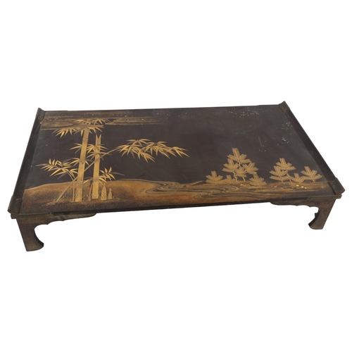 69 - A Japanese lacquer bed tray, with gilded and lacquer bamboo and landscape scene, 65 x 35cm