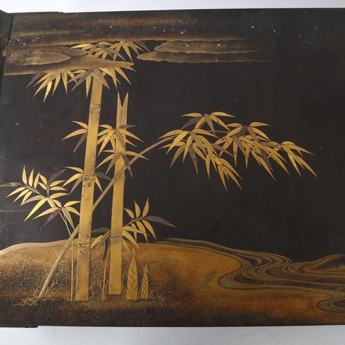 69 - A Japanese lacquer bed tray, with gilded and lacquer bamboo and landscape scene, 65 x 35cm