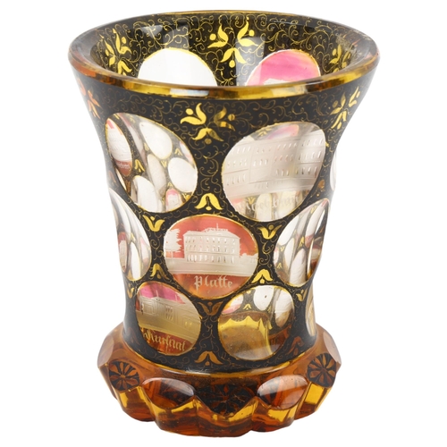 86 - A 19th century Bohemian amber flashed glass spa beaker, with engraved points of interest apertures, ... 