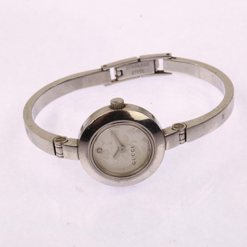 1034 - GUCCI - a lady's stainless steel 105 Series quartz bangle watch, floral diamond set silvered dial, s... 