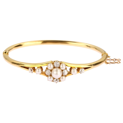 1106 - A Victorian cultured pearl and diamond cluster hinged bangle, unmarked 18ct gold settings with old-c... 