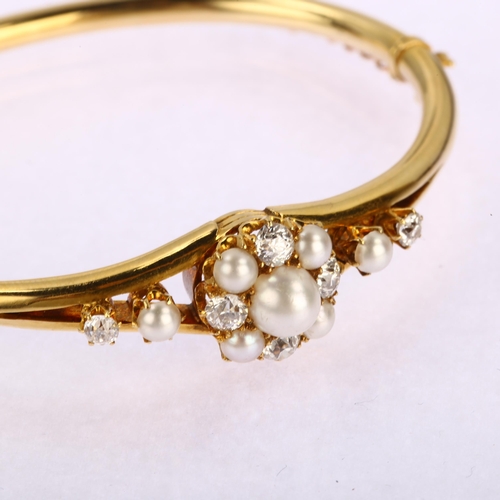 1106 - A Victorian cultured pearl and diamond cluster hinged bangle, unmarked 18ct gold settings with old-c... 