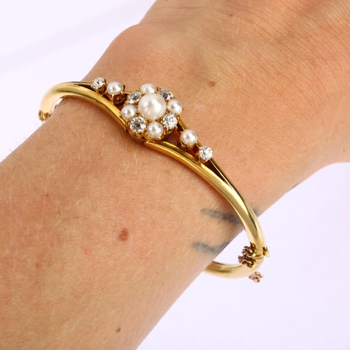 1106 - A Victorian cultured pearl and diamond cluster hinged bangle, unmarked 18ct gold settings with old-c... 