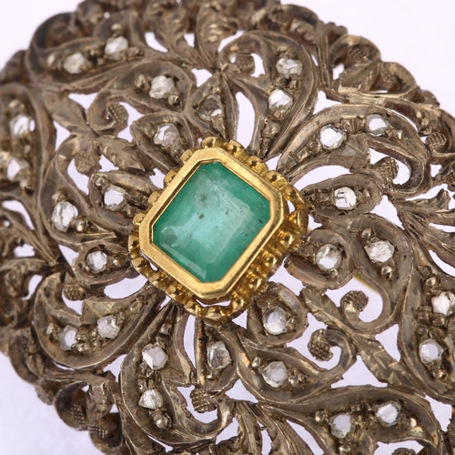 1109 - An emerald and diamond oval bombe brooch, unmarked gold and silver settings with central emerald ste... 