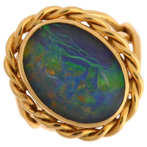 1116 - A late 20th century 18ct gold opal triplet ring, with rope twist surround and shank, maker's marks A... 