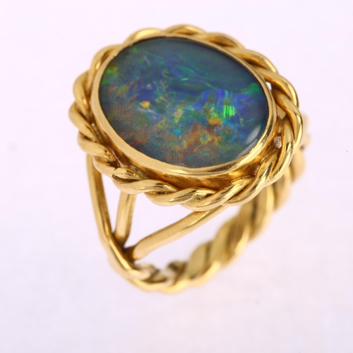 1116 - A late 20th century 18ct gold opal triplet ring, with rope twist surround and shank, maker's marks A... 