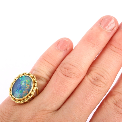 1116 - A late 20th century 18ct gold opal triplet ring, with rope twist surround and shank, maker's marks A... 