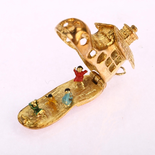 1127 - A mid-20th century 9ct gold shoe house fairytale kinetic charm/pendant, opening to reveal enamel fig... 