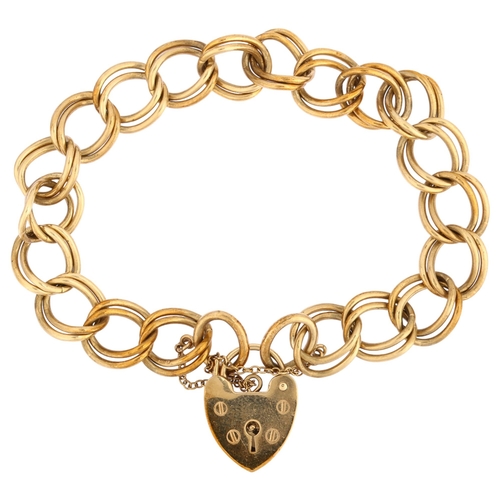 1132 - A late 20th century 9ct gold double curb link chain bracelet, with 9ct heart padlock, maker's marks ... 