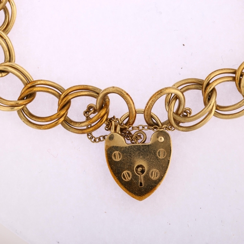 1132 - A late 20th century 9ct gold double curb link chain bracelet, with 9ct heart padlock, maker's marks ... 