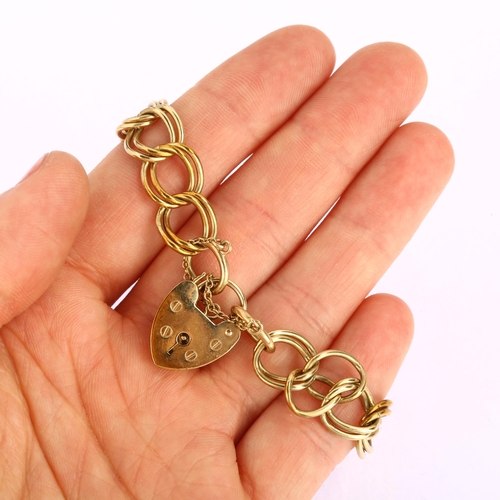 1132 - A late 20th century 9ct gold double curb link chain bracelet, with 9ct heart padlock, maker's marks ... 