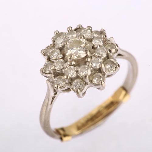 1146 - A late 20th century diamond cluster ring, unmarked white metal settings with modern round brilliant-... 