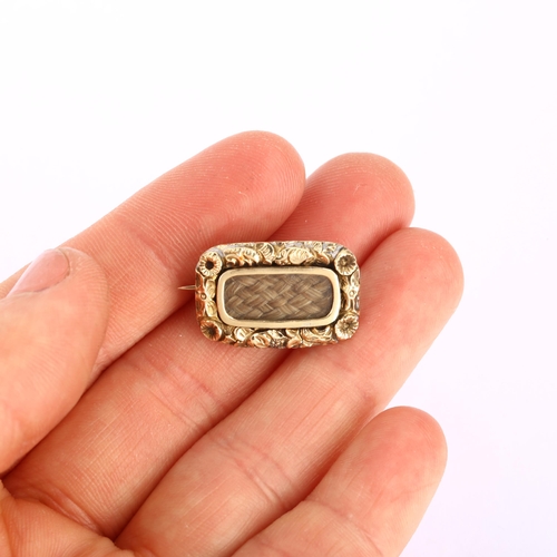 1147 - A Georgian woven hair memorial brooch, unmarked gold closed-back settings with floral border and cen... 