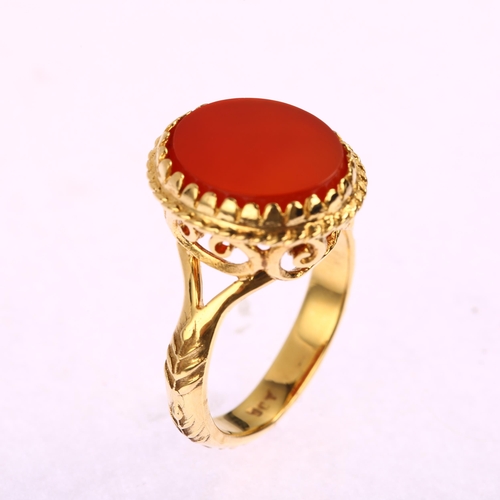 1155 - An Antique 9ct gold carnelian signet ring, with openwork scrolled bridge and raised leaf shank, 17.5... 