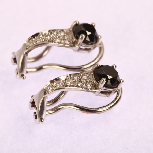 1159 - A pair of modern black diamond and diamond clip-on earrings, unmarked white metal settings with mode... 