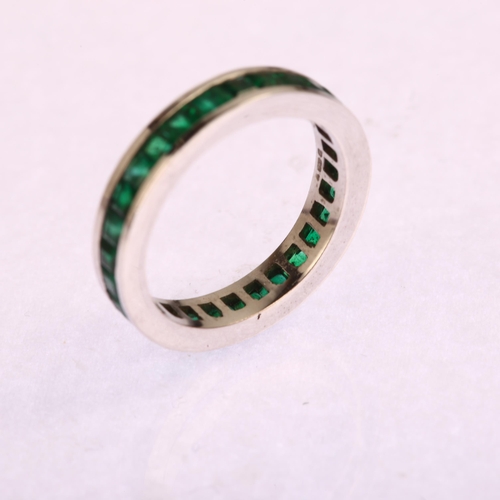 1163 - A modern 18ct white gold emerald full eternity ring, channel set with square step-cut emeralds, band... 