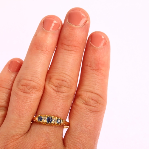 1184 - An early 20th century 18ct graduated five stone sapphire and diamond half hoop ring, setting height ... 