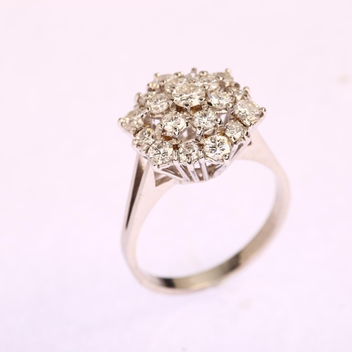 1191 - An 18ct white gold diamond flowerhead cluster ring, prong set with modern round brilliant-cut diamon... 