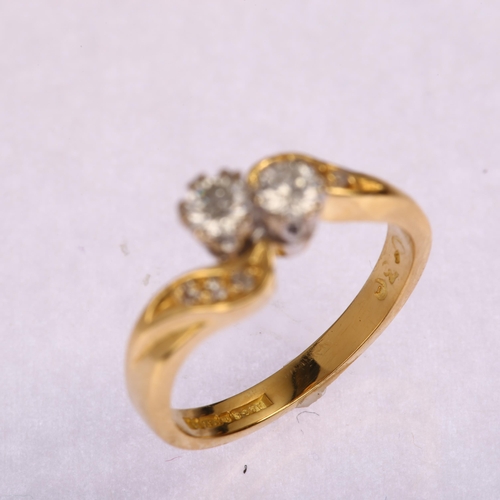 1195 - A late 20th century 18ct gold two stone diamond crossover ring, set with modern round brilliant-cut ... 