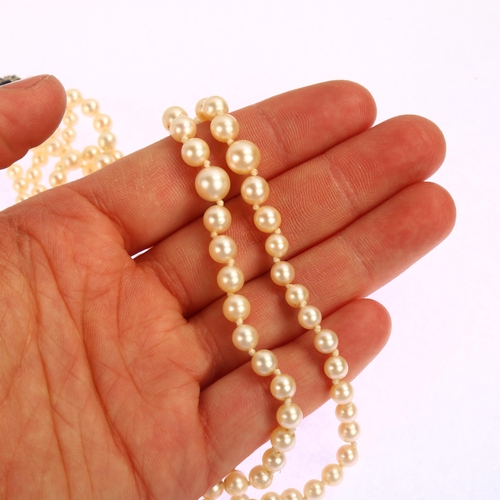 1204 - A mid-20th century graduated double-strand cultured pearl necklace, with 9ct white gold stone set cl... 