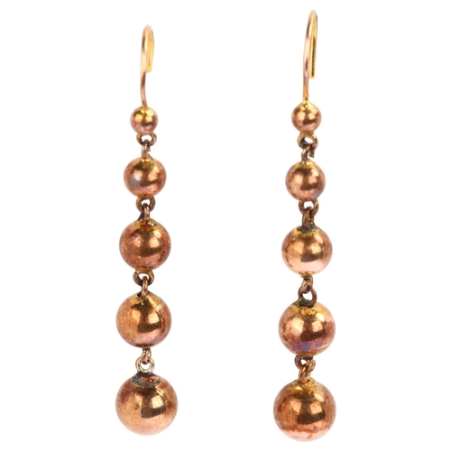 1209 - A pair of graduated ball drop earrings, unmarked yellow metal settings, with shepherd hook fittings,... 