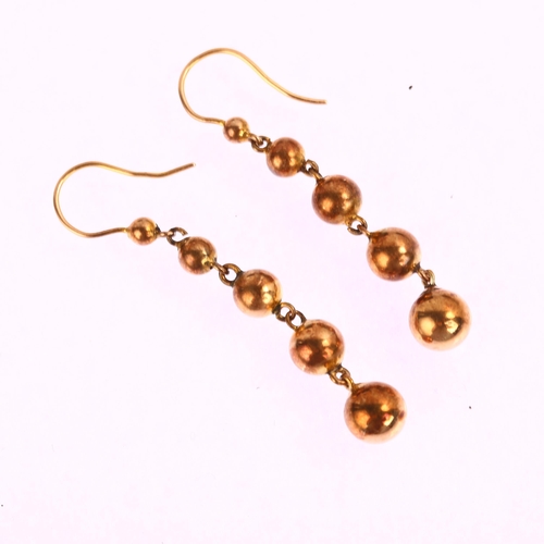 1209 - A pair of graduated ball drop earrings, unmarked yellow metal settings, with shepherd hook fittings,... 