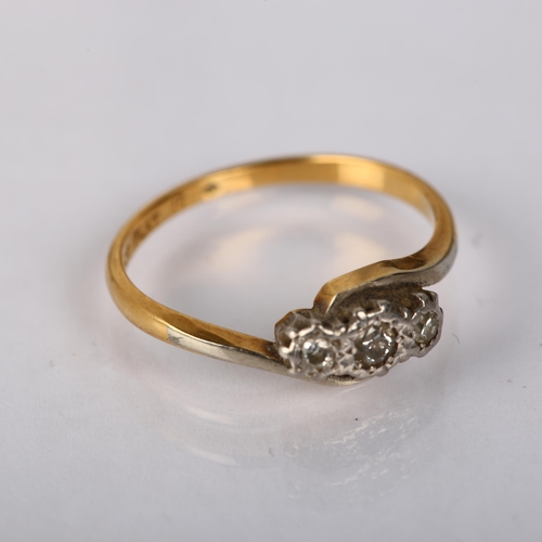 1214 - An early 20th century 18ct gold three stone diamond crossover ring, platinum-topped with illusion se... 