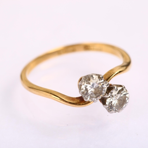 1220 - An early 20th century 18ct gold two stone diamond crossover ring, prong set with modern round brilli... 