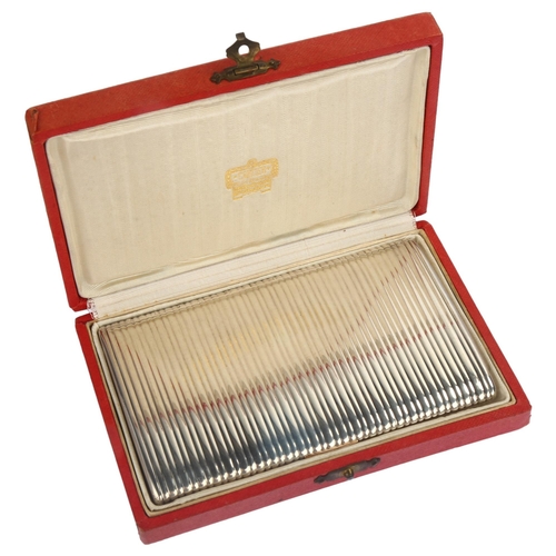 1225 - CARTIER - a French silver and rose gold ribbed cigarette case, with 3 interior compartments and engr... 