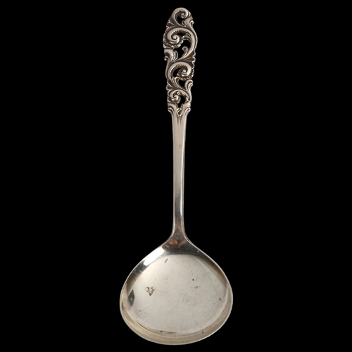 1463 - BRODRENE MYLIUS - an Art Deco Norwegian silver serving spoon, with pierced foliate handle, length 19... 