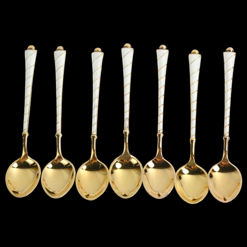 1466 - EGON LAURIDSEN - a set of 7 Danish vermeil sterling silver and white enamel coffee spoons, length 9.... 